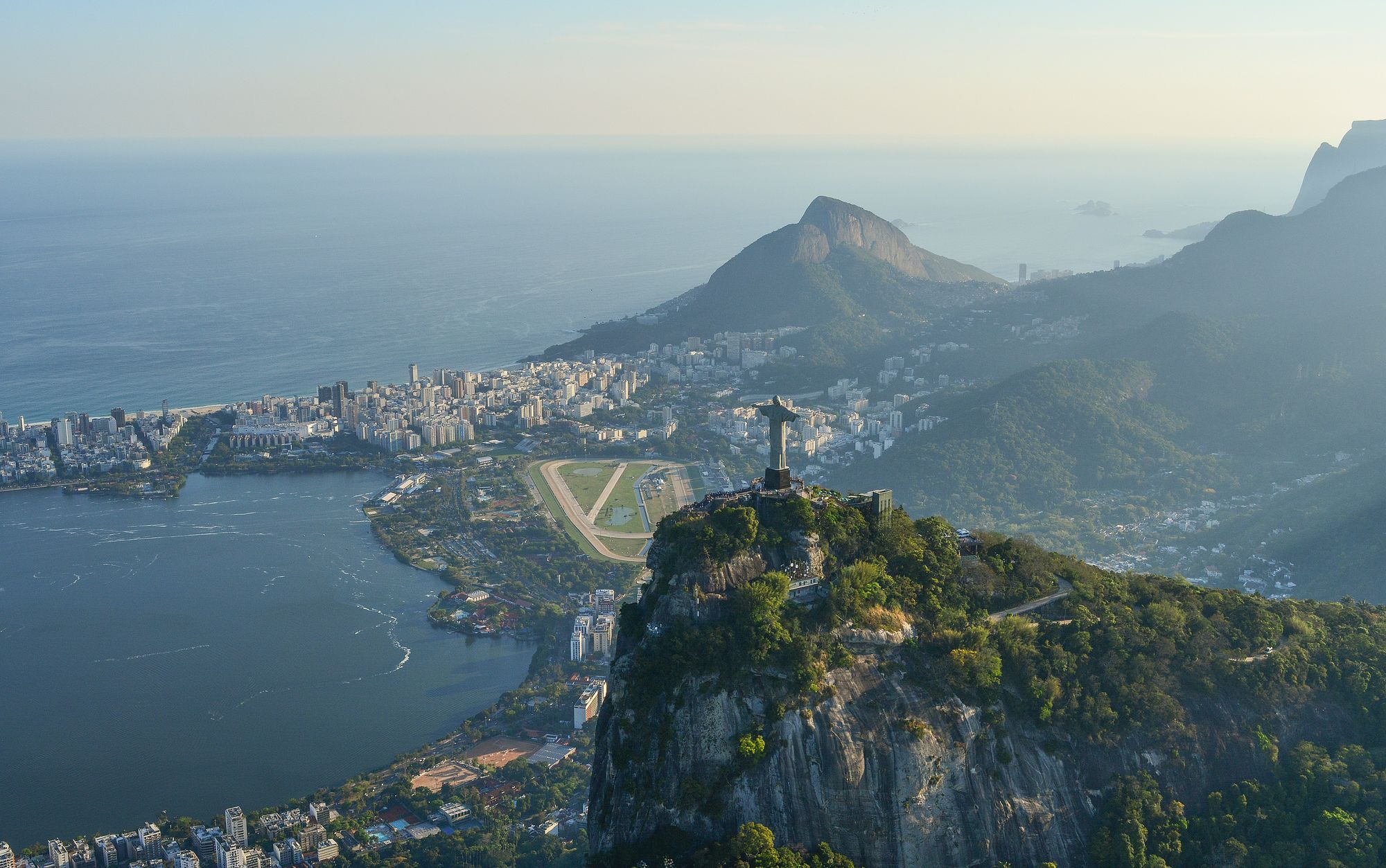 Christ the Redeemer statue looms above Rio de Janeiro and ocean