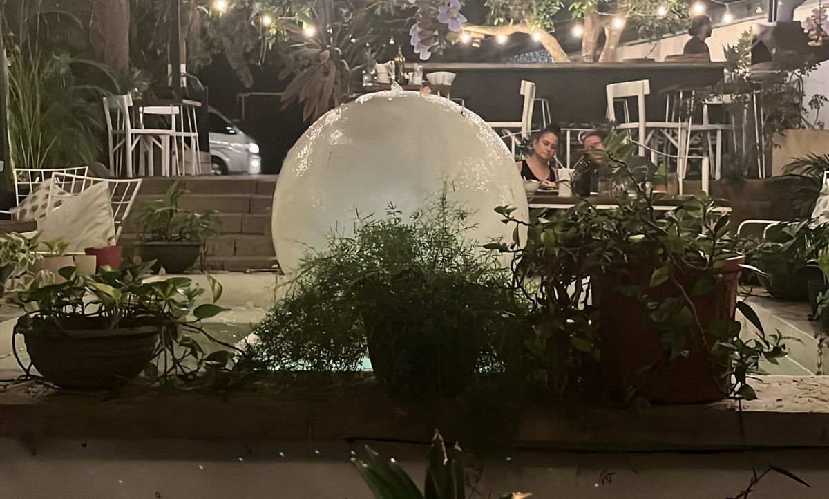A giant glass white sphere sits among plants at a vegan restaurant in Costa Rica