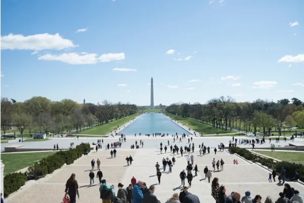 The Washington Monument overlooks the mall as people and remote workers wander the DC grounds