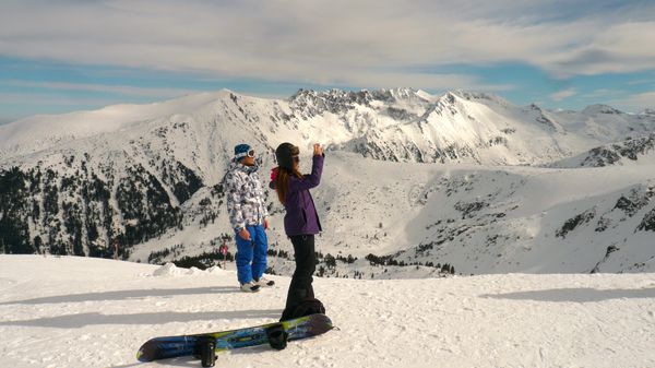 Two skiiers enjoy the snow-capped mountains of Bansko, Bulgaria.